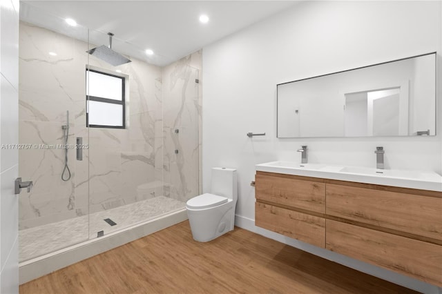 665 NE 117th St, Biscayne Park, FL 33161 - bathroom with double vanity, a marble finish shower, wood finished floors, and recessed lighting