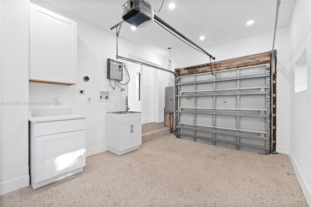 garage with recessed lighting, a garage door opener, baseboards, and a sink