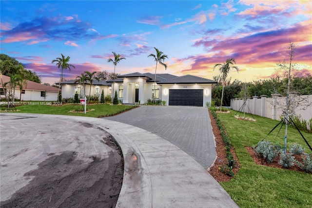 view of front of home with a lawn and a garage