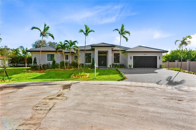 view of front facade featuring a garage and a front lawn