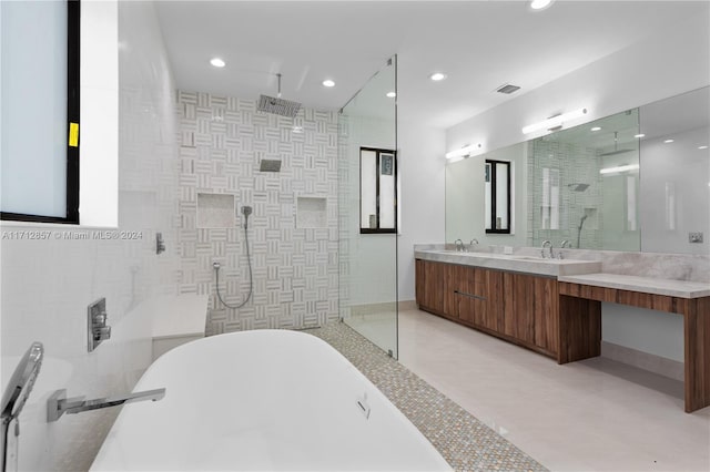 bathroom with plus walk in shower, vanity, concrete flooring, and tile walls