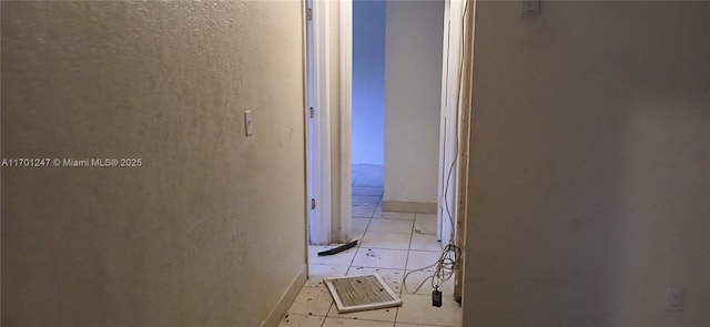 corridor with light tile patterned floors