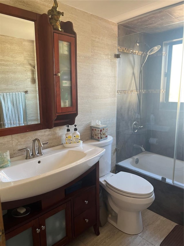 full bathroom with toilet, tasteful backsplash, tile walls, shower / washtub combination, and vanity