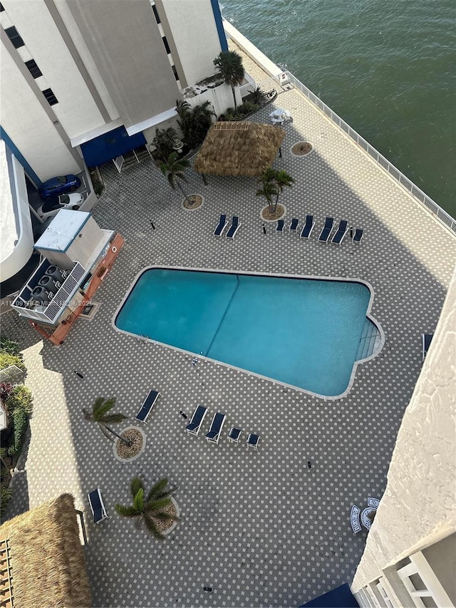 view of swimming pool featuring a water view