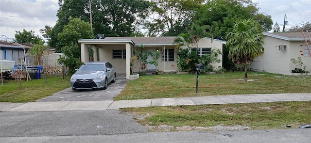 view of front facade with a carport and a front lawn