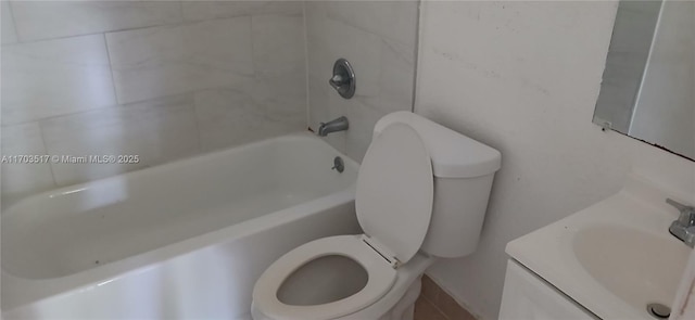 full bathroom featuring vanity, tiled shower / bath combo, and toilet