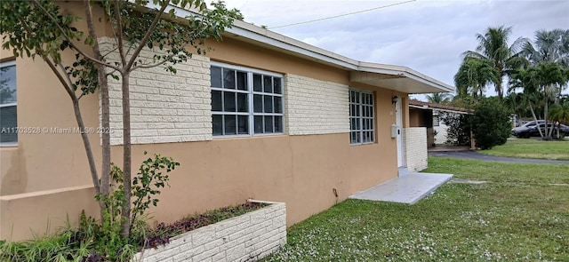 view of side of home featuring a yard