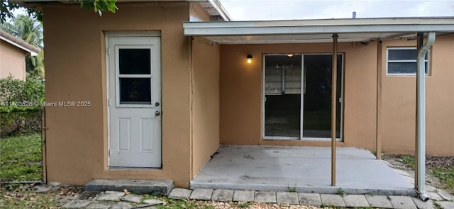 doorway to property with a patio area