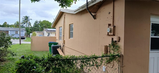 view of side of property with central air condition unit