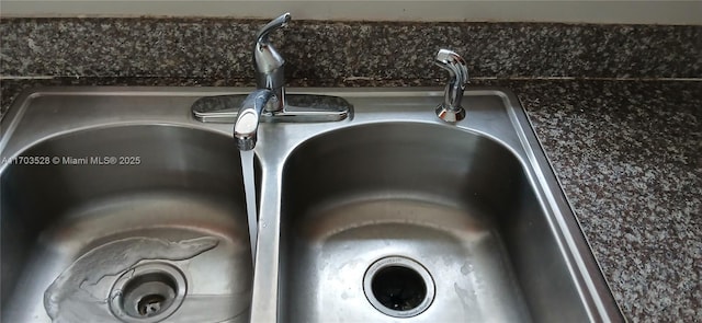 interior details featuring dark stone counters and sink