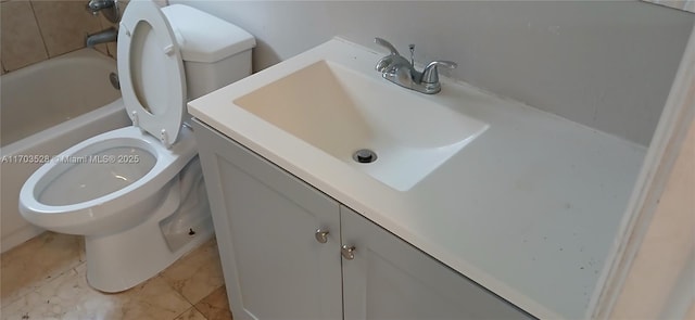 bathroom featuring a bathtub, toilet, and vanity