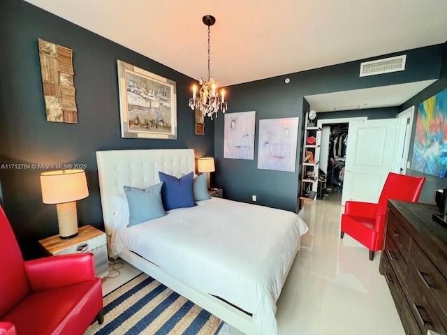 bedroom featuring an inviting chandelier, a spacious closet, and a closet