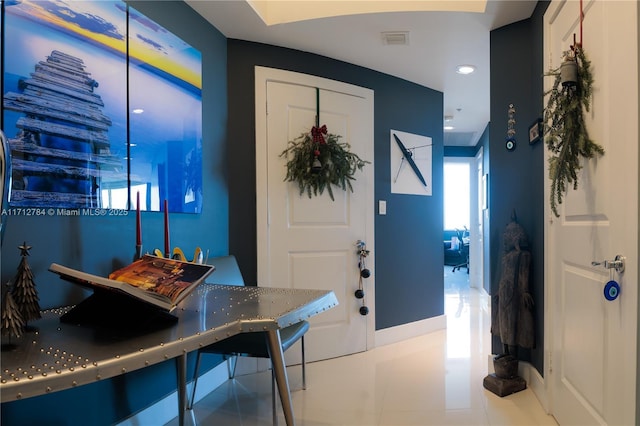 tiled foyer entrance featuring baseboards and visible vents