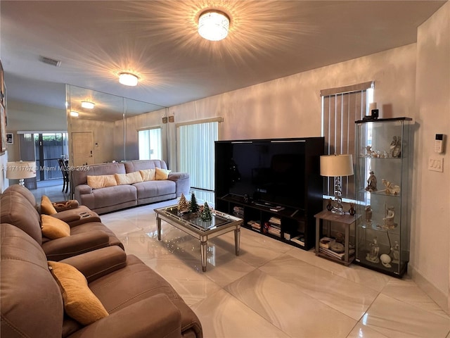 living room featuring light tile patterned floors and vaulted ceiling