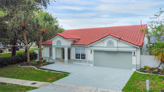 mediterranean / spanish-style house with a front yard and a garage