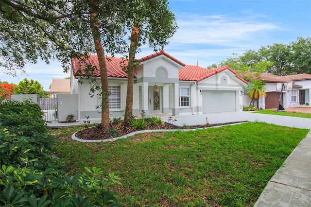 mediterranean / spanish-style house with a garage and a front yard