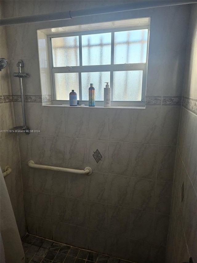 bathroom with a tile shower