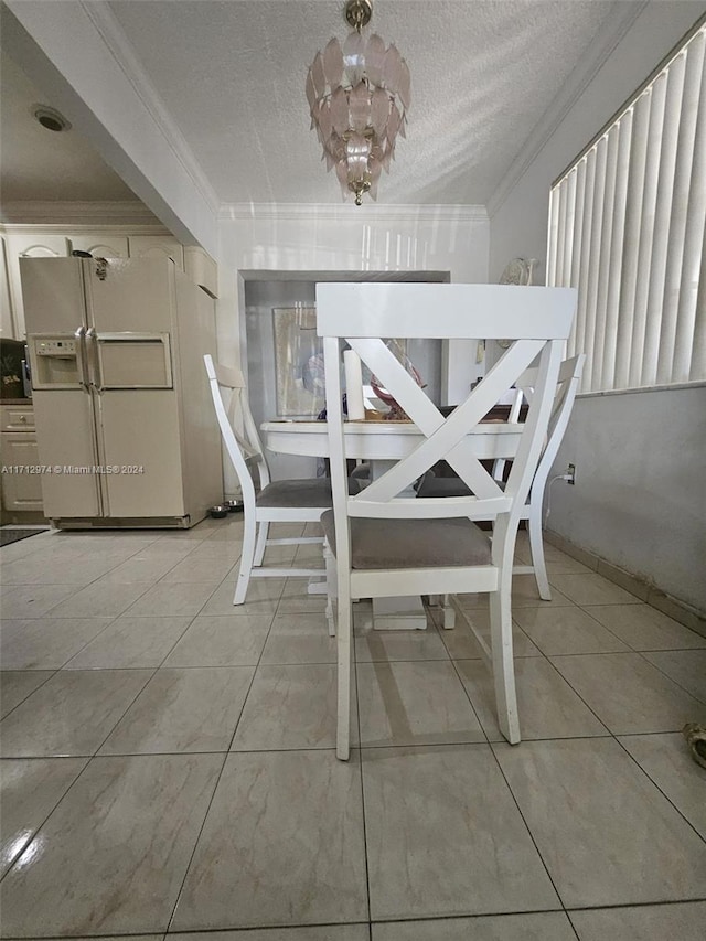 unfurnished dining area featuring light tile patterned floors, a chandelier, a textured ceiling, and ornamental molding