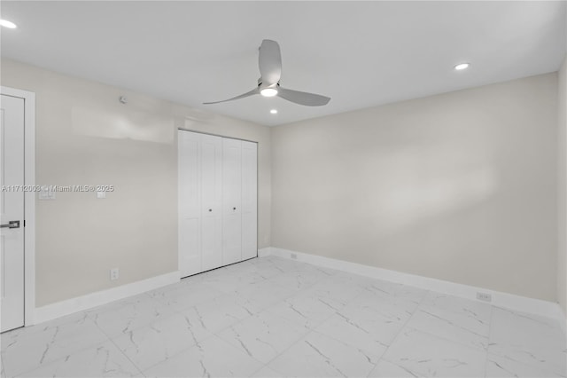 unfurnished bedroom with ceiling fan and a closet