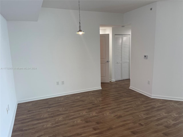 spare room with dark hardwood / wood-style floors