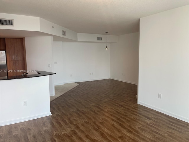 unfurnished living room featuring dark hardwood / wood-style floors