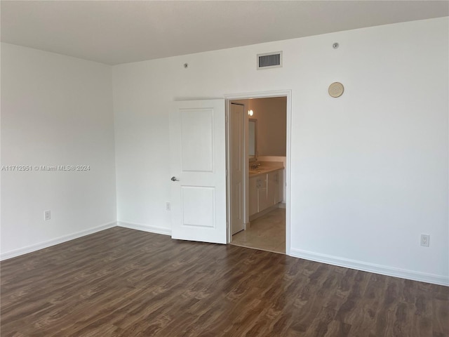 spare room with dark hardwood / wood-style flooring