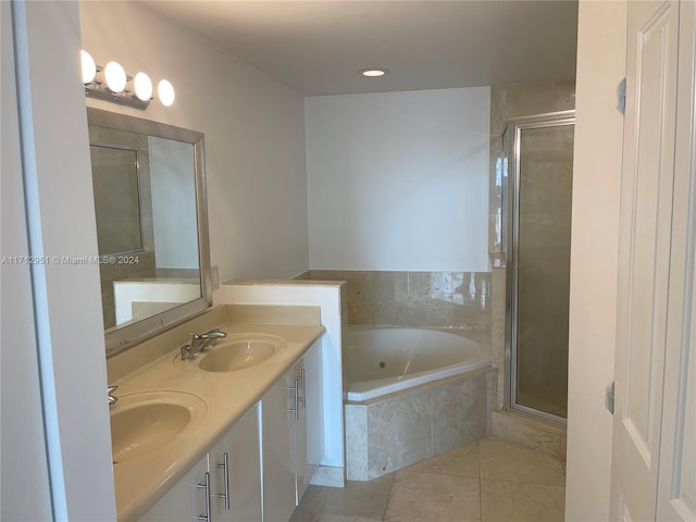 bathroom with vanity and shower with separate bathtub