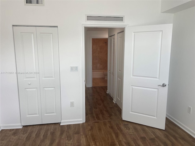 unfurnished bedroom with dark wood-type flooring