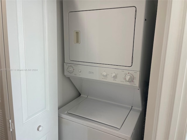 clothes washing area featuring stacked washer / drying machine