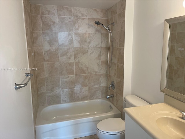 full bathroom with vanity, tiled shower / bath combo, and toilet