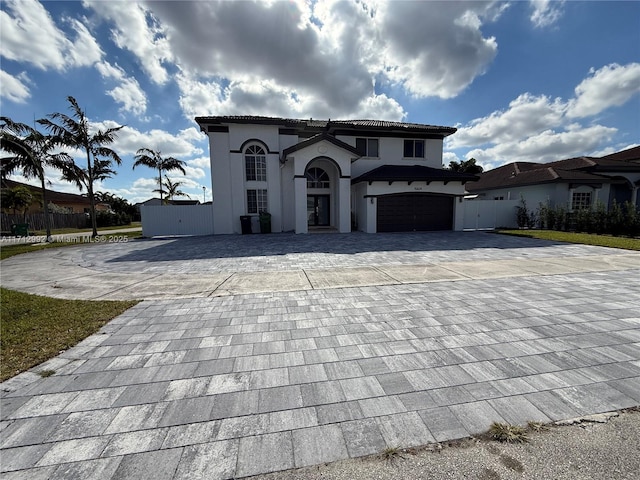 mediterranean / spanish home featuring a garage