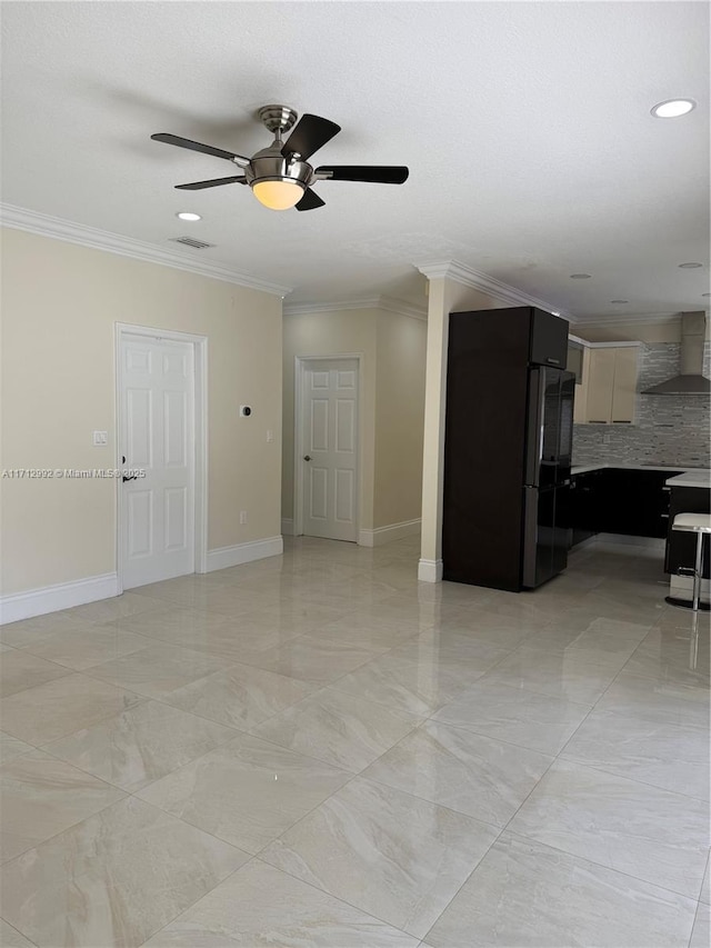 unfurnished living room featuring ceiling fan and crown molding