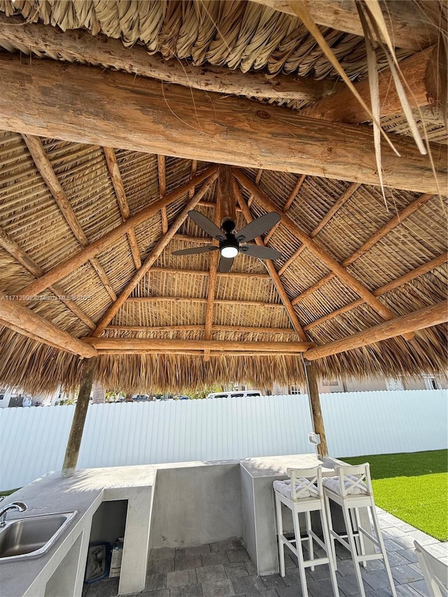 view of patio / terrace featuring a gazebo, ceiling fan, and an outdoor wet bar