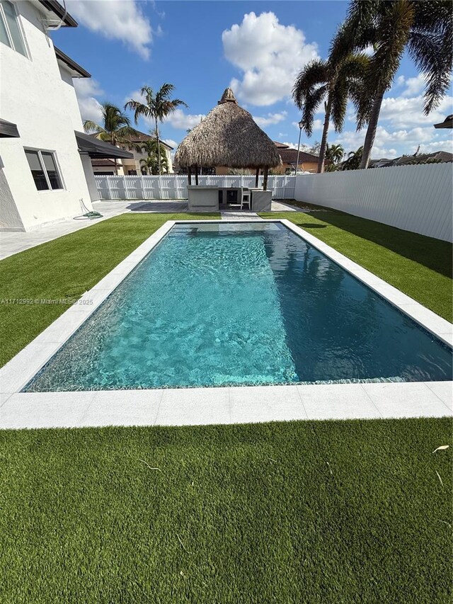 view of pool with a gazebo and a lawn