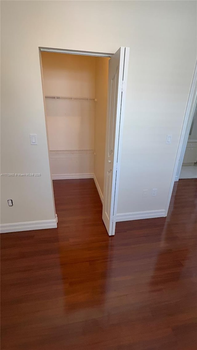 hallway featuring dark hardwood / wood-style floors