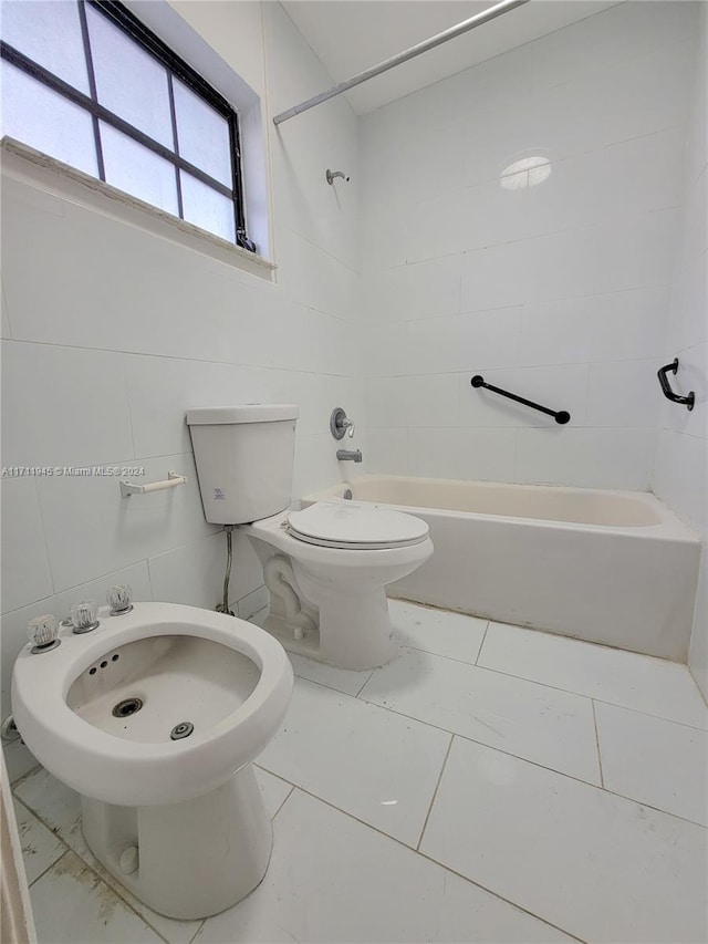 bathroom with tiled shower / bath, a bidet, toilet, and tile walls