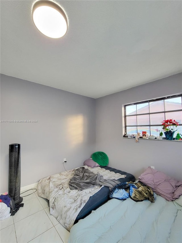 bedroom with light tile patterned flooring