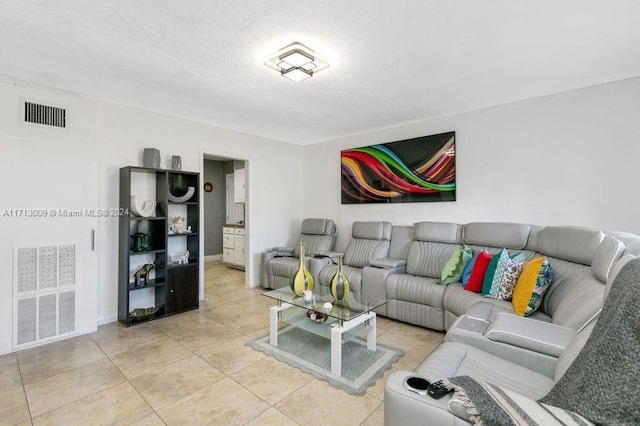 living room with light tile patterned flooring and a textured ceiling