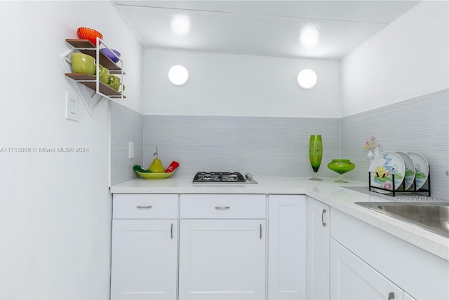 kitchen featuring white cabinets and stainless steel gas cooktop