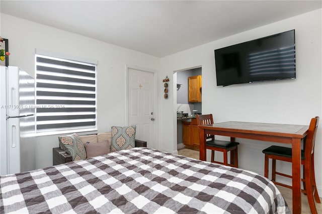 bedroom featuring white fridge