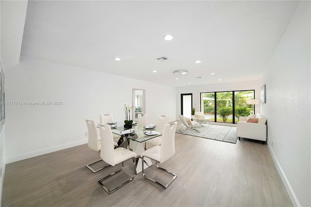 dining room featuring recessed lighting, wood finished floors, visible vents, and baseboards