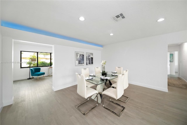 dining space with hardwood / wood-style flooring