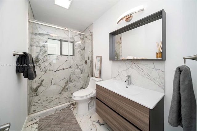 bathroom with vanity, toilet, and a shower with shower door