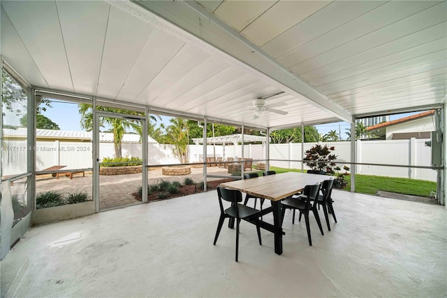 sunroom with beamed ceiling and ceiling fan