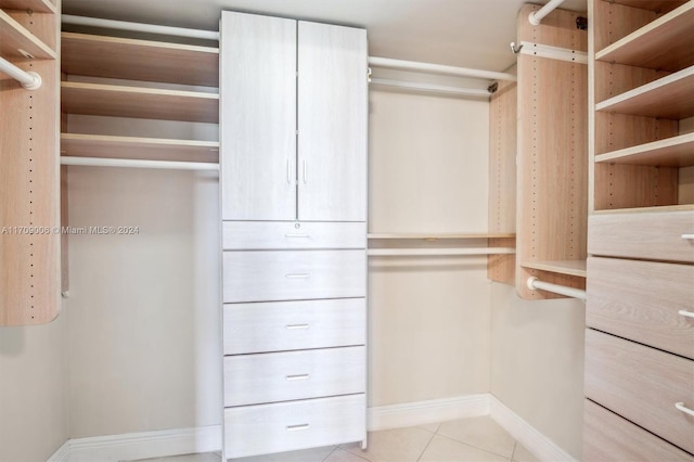 spacious closet with light tile patterned floors