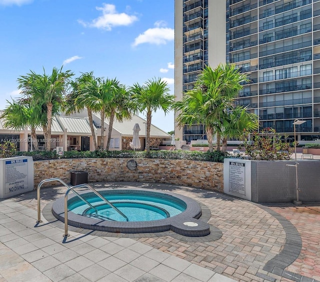 view of pool with a community hot tub