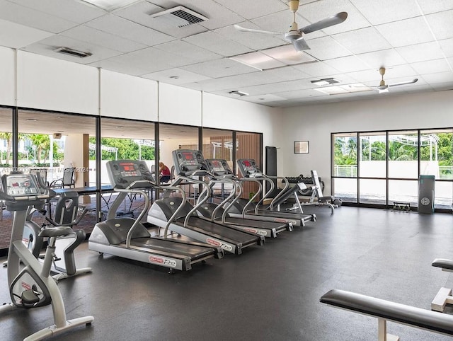 workout area with ceiling fan and a drop ceiling