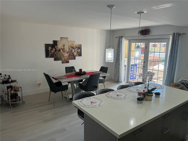 dining area with french doors and light wood-type flooring