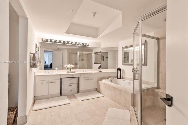 bathroom featuring tile patterned flooring, vanity, and separate shower and tub