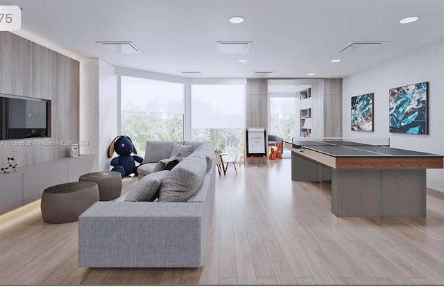 living room with expansive windows and light hardwood / wood-style floors